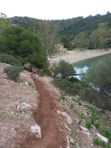A freshly dug hiking trail on Poros island with a beach at the background