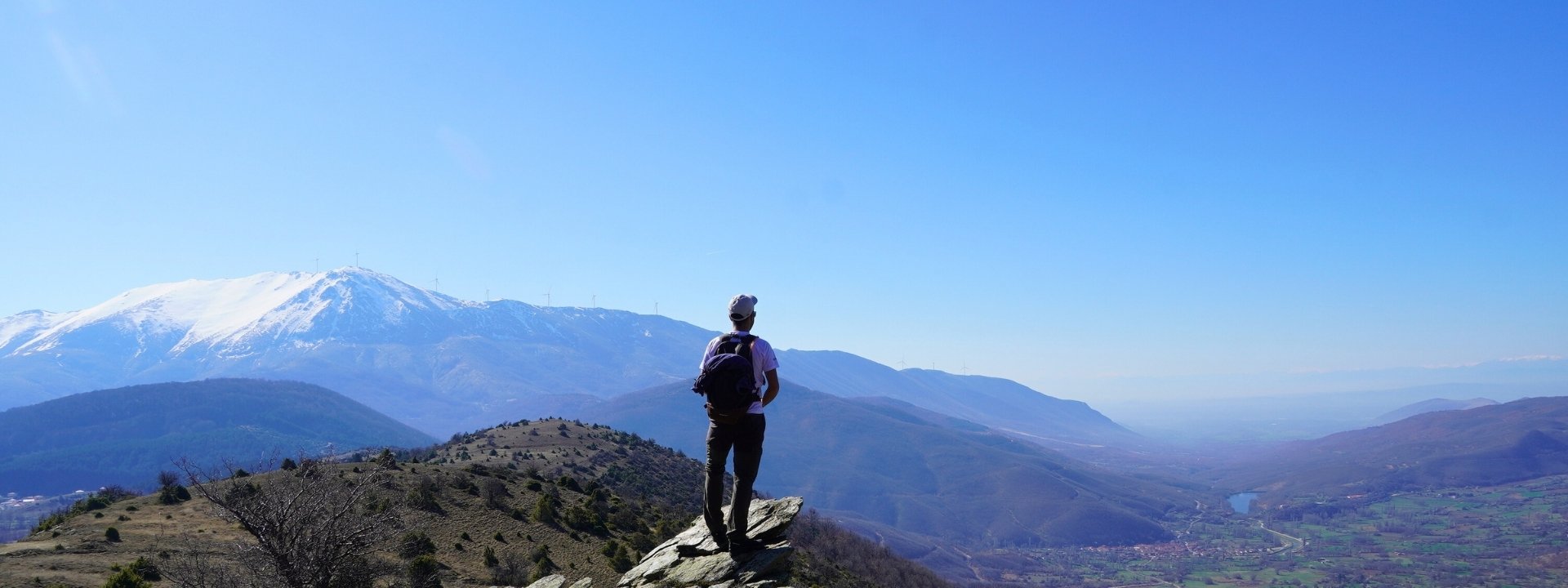 A hiker looking at Greek mountains